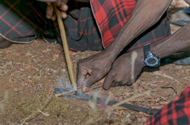 Akie men lighting fire